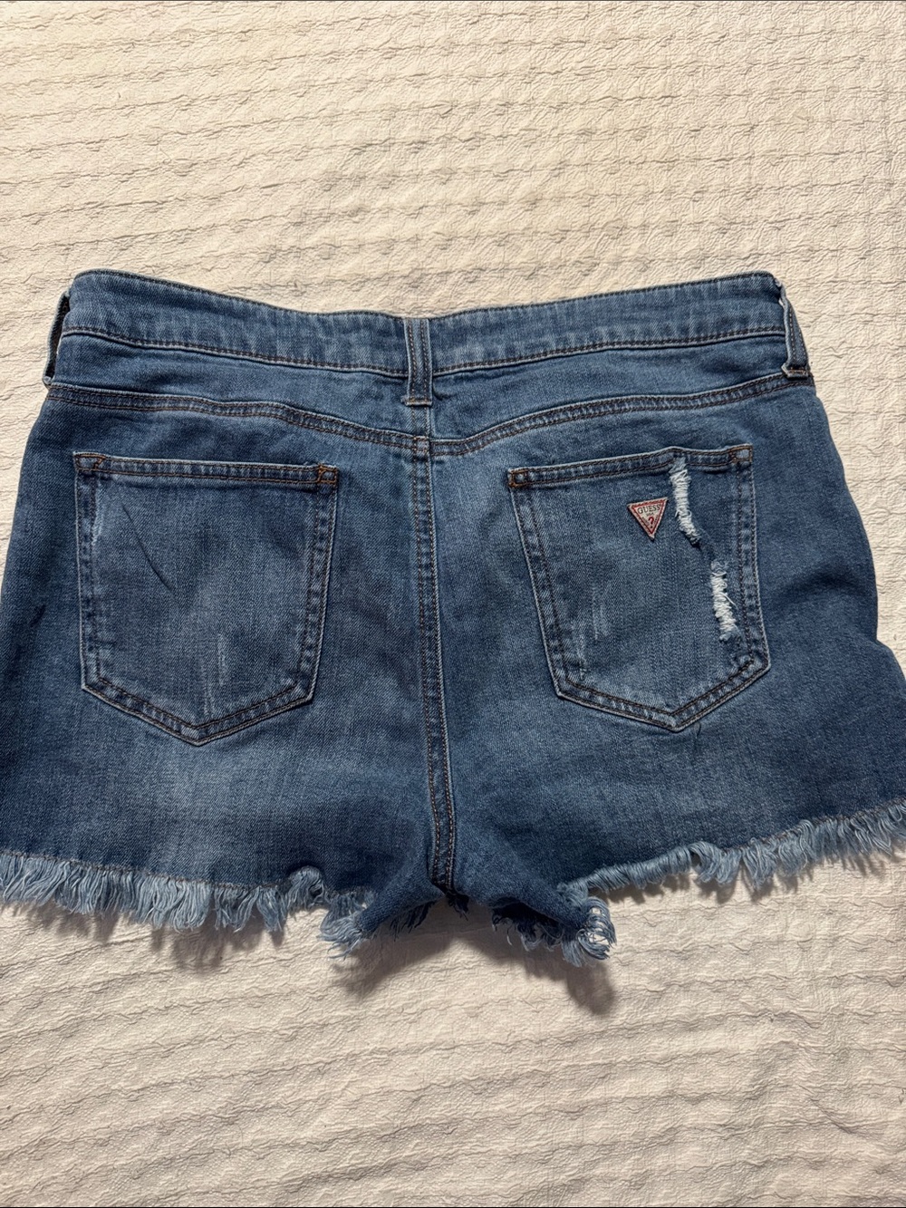 GUESS Denim Cutoff Shorts in Medium Blue with Frayed Hem